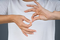 Two hands communicating in sign language.