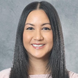 Headshot of Cambodian American NIH Management Intern, Phalla Messina wearing a light pink shirt against a grey background