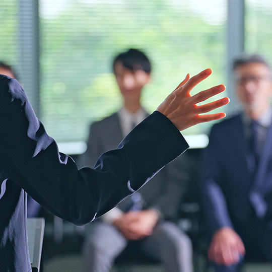 A woman presents during an intimate lecture. 