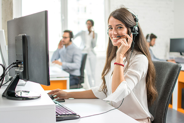 Woman at computer providing real-time transcription via CART service 