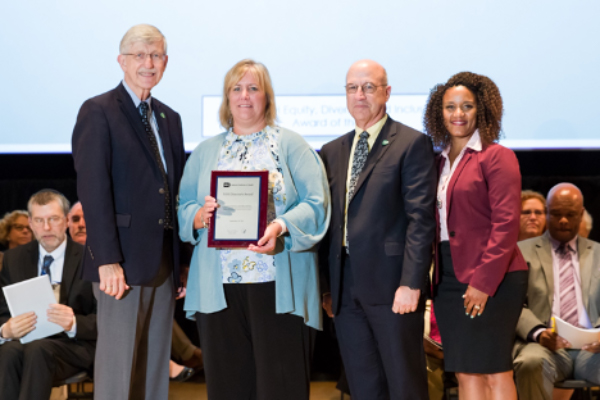 From left, Francis Collins, M.D., Ph.D., Tricia Coffey, James K. Gilman, M.D., and Treava Hopkins-Laboy