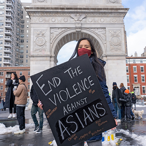 Protestor holds a sign at the End the Violence Towards Asians rally.