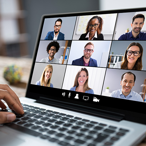 A virtual meeting with several attendees on a laptop screen