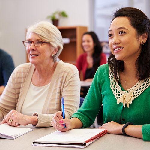 2 women sitting in an educational setting