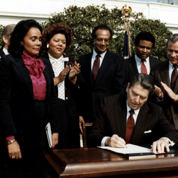 President Ronald Reagan signs the MLK Holiday into law.