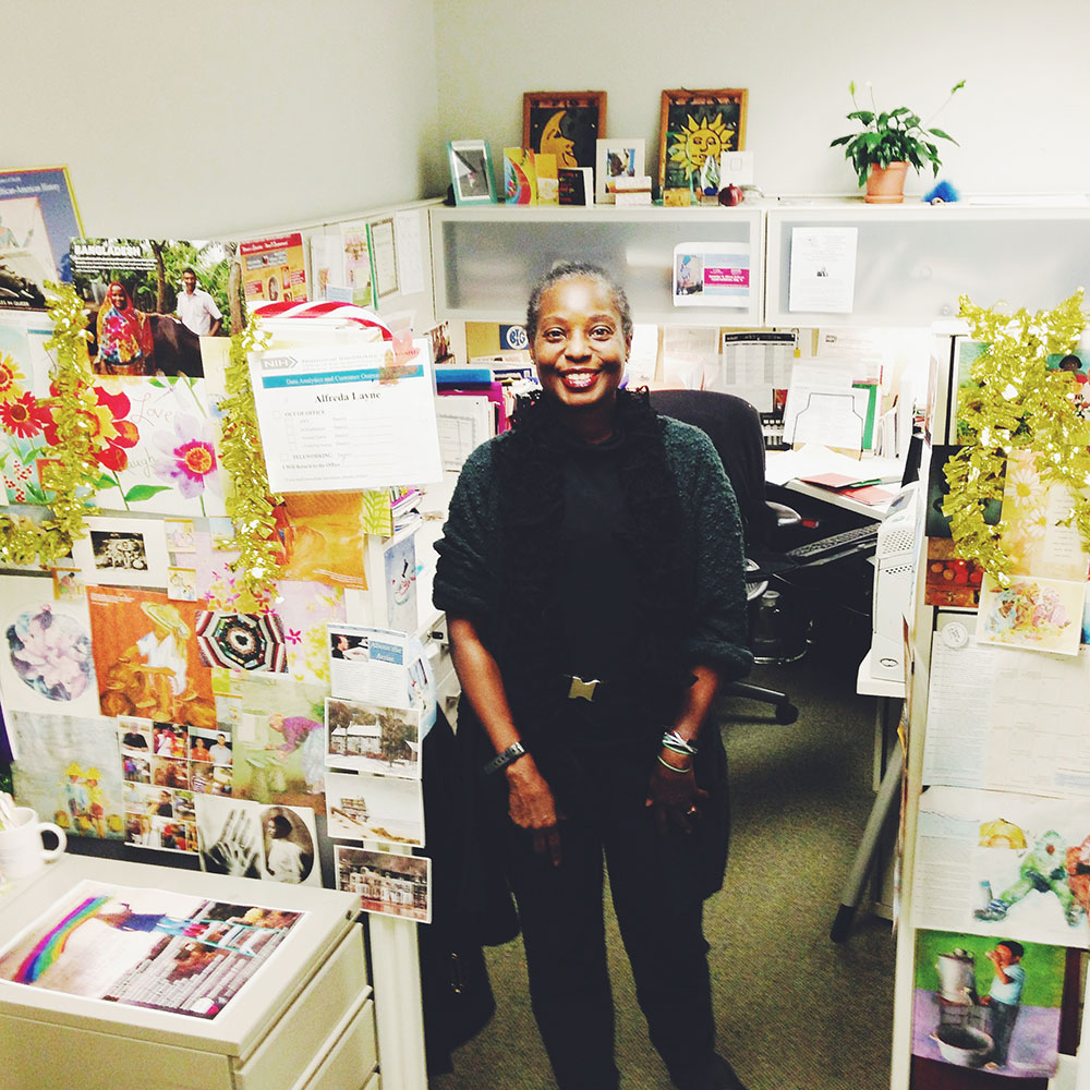 Alfreda Layne sitting in front of her cubicle.