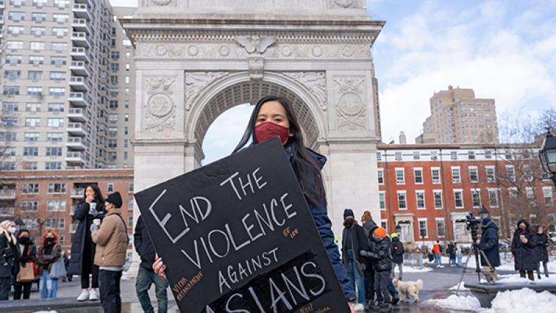 Protestor holds a sign at the End the Violence Towards Asians rally.